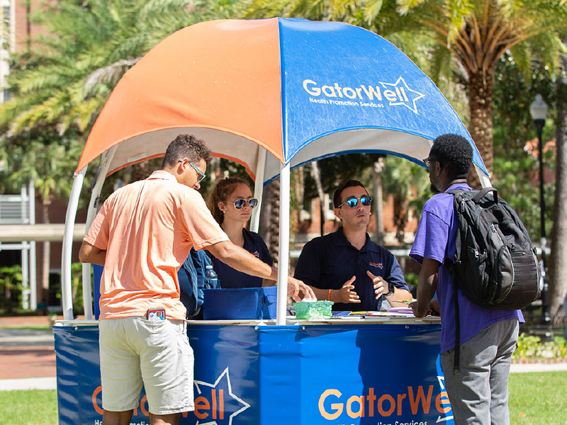 Students talking to people at a booth